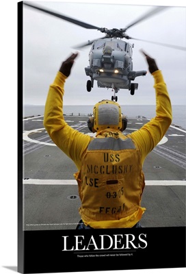 Military Poster: Petty Officer guides an SH-60R Sea Hawk helicopter