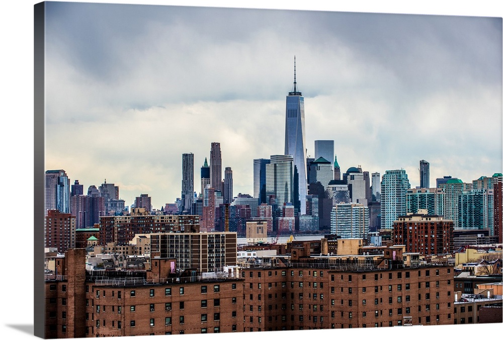 View of the New York City skyline over Manhattan with cloudy skies.