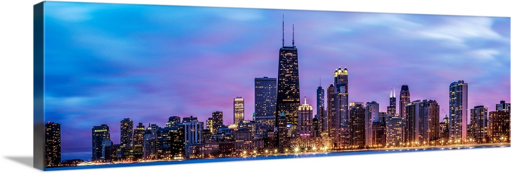 Photo of Chicago skyline at night under cotton candy colored clouds.