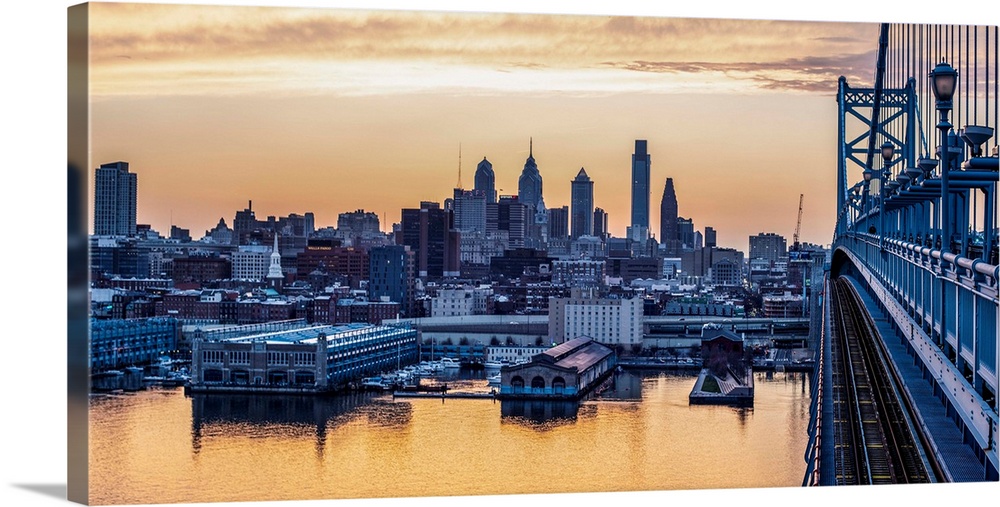 View of Philadelphia's city skyline against a dewy melon colored sky.