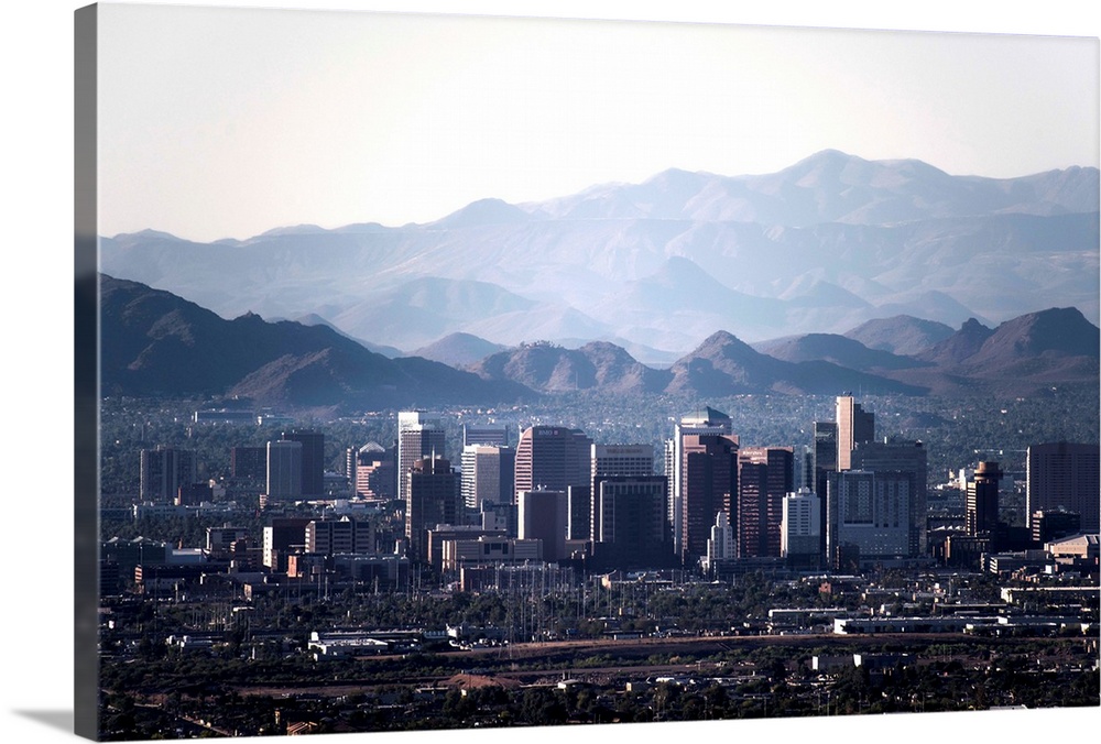 Photograph of the Phoenix, Arizona skyline with hazy desert mountains in the background.