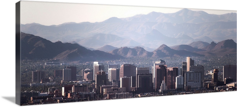 Panoramic photograph of the Phoenix, Arizona skyline with hazy desert mountains in the background.