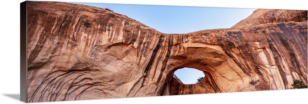 Bright red rock contrasting with the blue sky at the Bowtie Arch, Arches National Park, Utah.