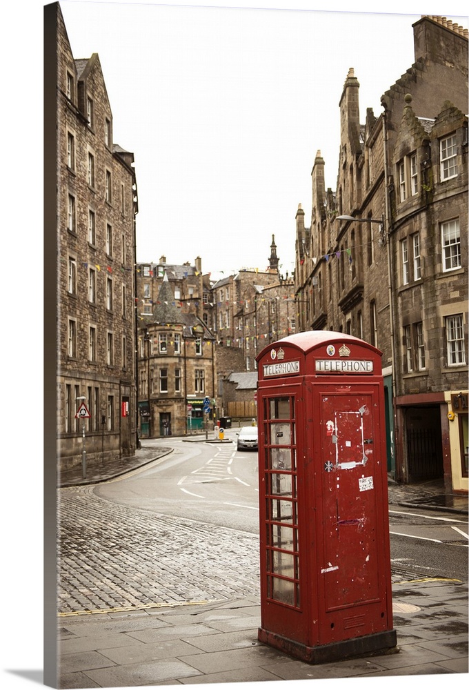 Photograph of a red telephone booth on a street corner in Edinburgh, surrounded by beautiful architecture.