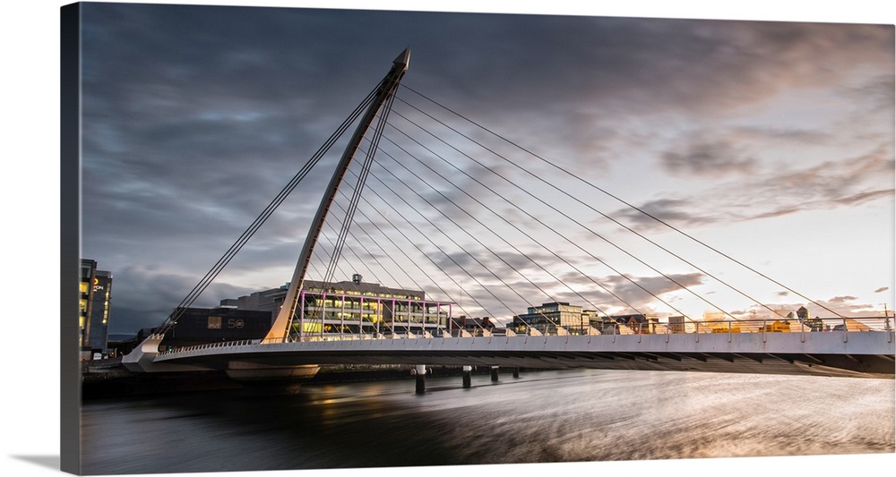 Panoramic photograph of the Samuel Beckett Bridge, a cable-stayed bridge in Dublin, Ireland going across the River Liffey,...
