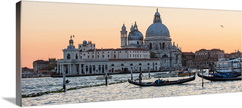 Panoramic photograph of the Santa Maria della Salute (The Salute) from the water at sunset.