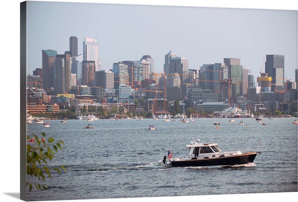 A boat passes by with Seattle's city skyline in the background. View from Lake Union, Washington.