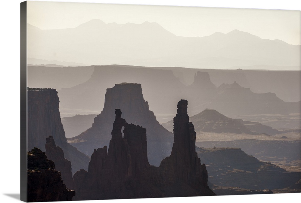 Hazy morning light gives the eroded rock structures a soft blue hue in Canyonlands National Park, Moab, Utah.