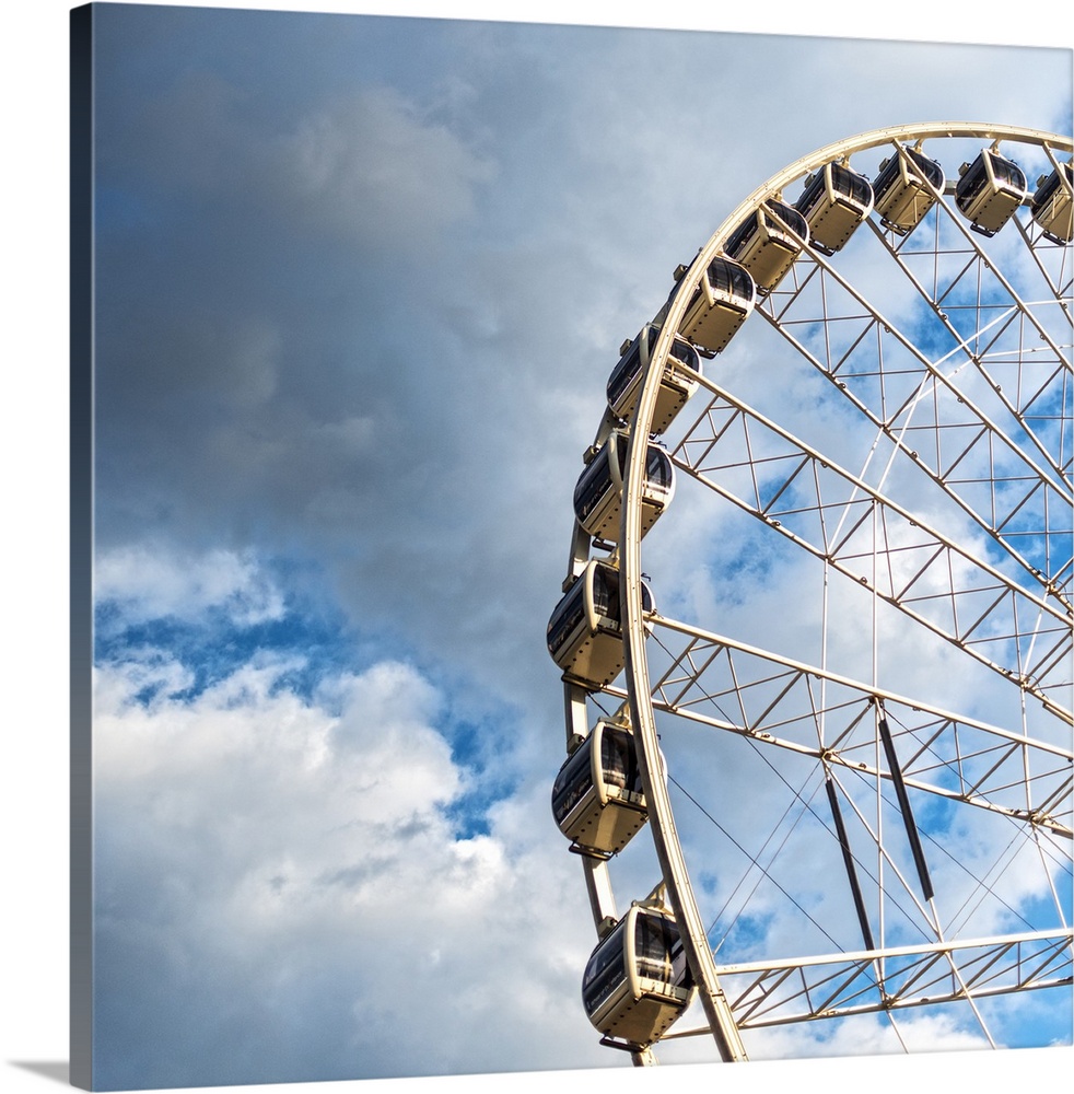 The gondolas of SkyView Atlanta Ferris Wheel, a 20-story wheel, against a backdrop of clouds over Centennial Park, Atlanta...