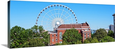SkyView Atlanta, a giant Ferris Wheel, seen over the treeline in Centennial Park
