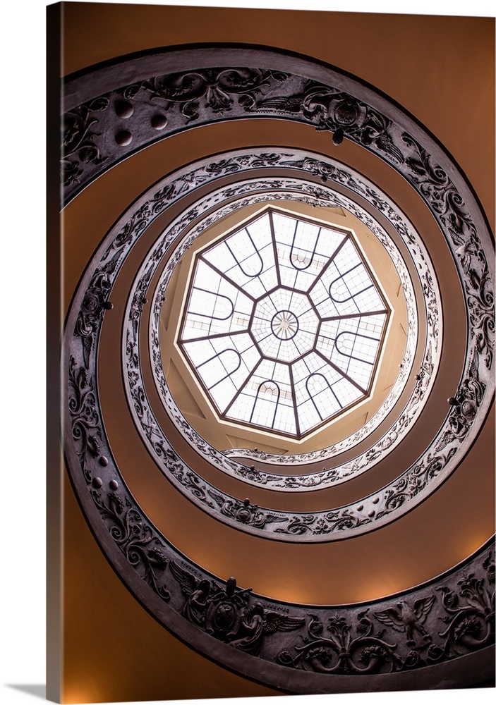 Photograph of the spiral staircase in the Vatican History Museum leading up to the beautiful skylight window.