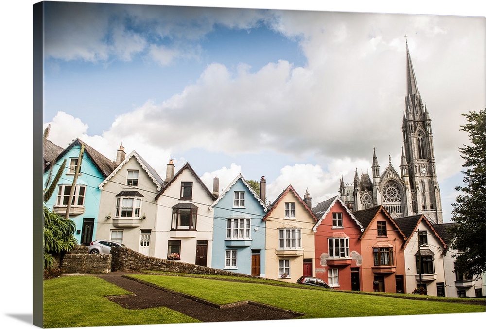 Colorful facades from a row of houses in the Old Town, with St. Colman's cathedral in the background, Cobh, County Cork, I...