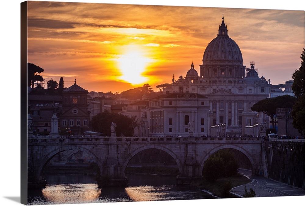 Photograph of St. Peter's Basilica with Ponte Sant'Angelo over the river Tober at sunset.