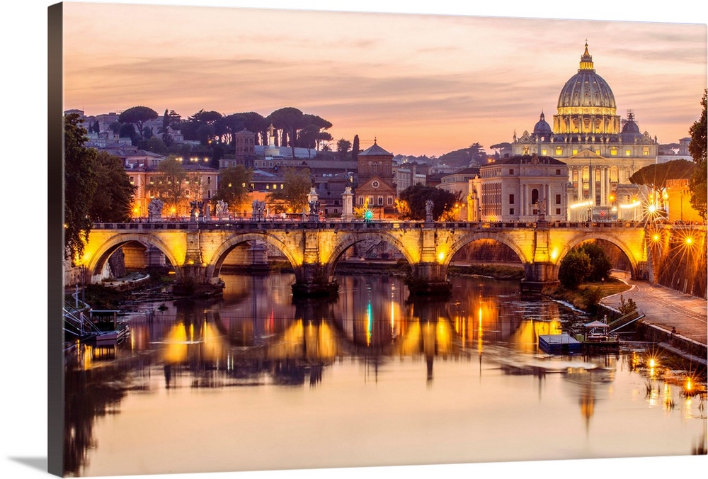 A view of St. Peter's Basilica in the Vatican and the Ponte Sant'Angelo  spanning across the river Tober in Rome, Italy at...