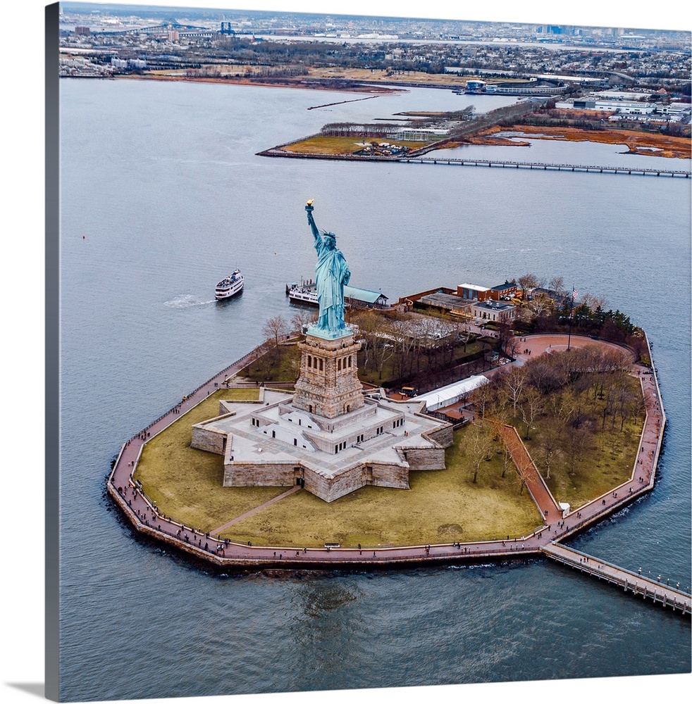 Aerial view of the Statue of Liberty on Liberty Island on a grey day.