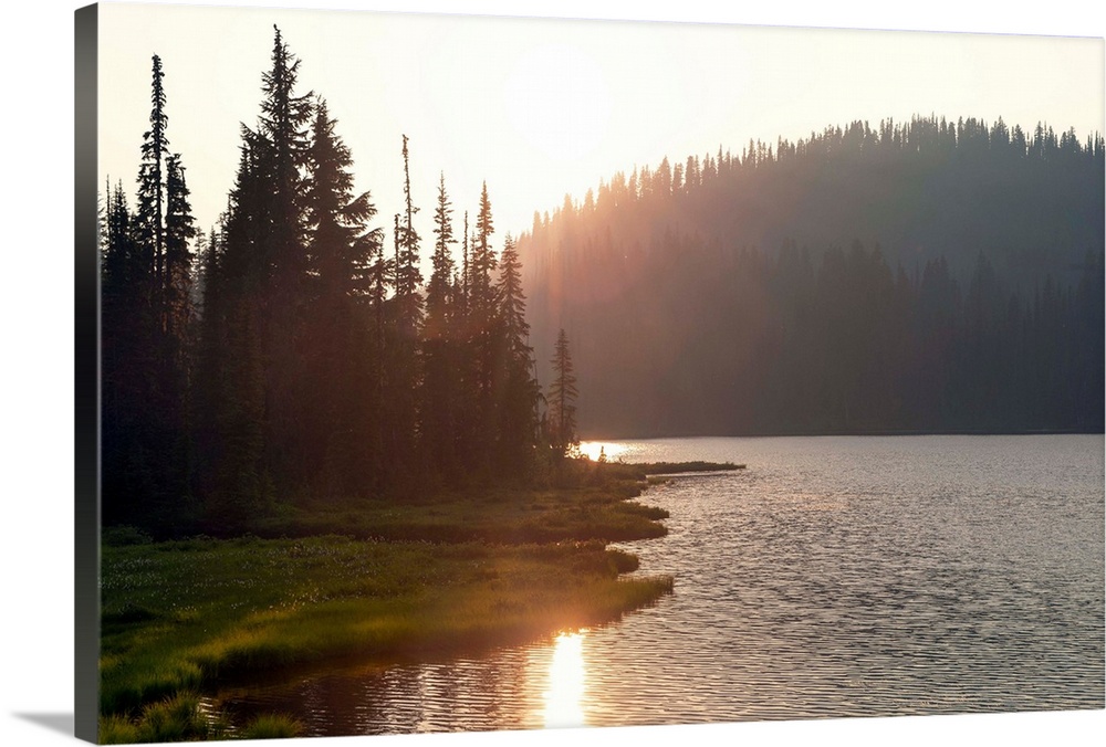 The sun sets on a lake in Mount Rainier National Park, Washington.