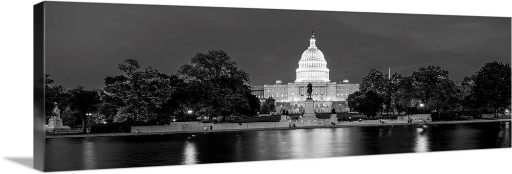 Panoramic photograph of the U.S. Capitol Building at dusk with the Capitol Reflecting Pool.
