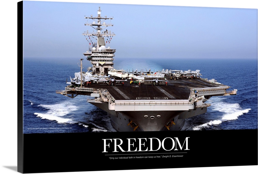 An immense photograph taken of a US navy ship in the open ocean with the word "Freedom" just below it.