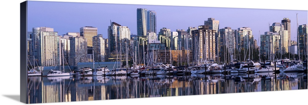 Panoramic photograph of a purple sunset over the Vancouver skyline and harbor reflecting onto the False Creek River, Briti...