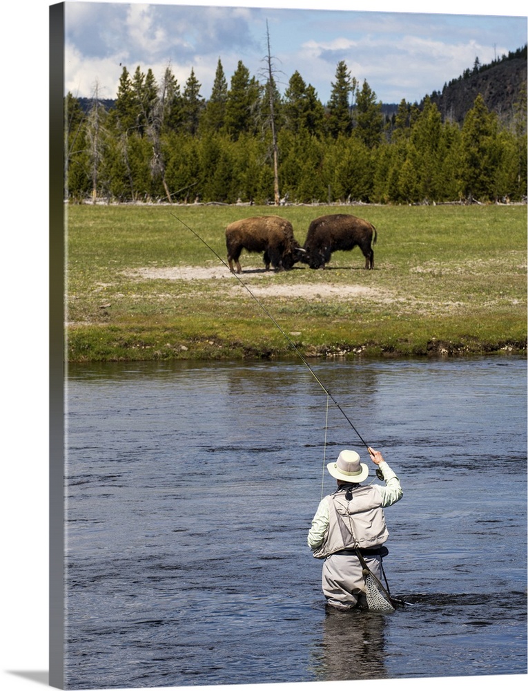 Person fly fishing in a river at Yellowstone National Park.