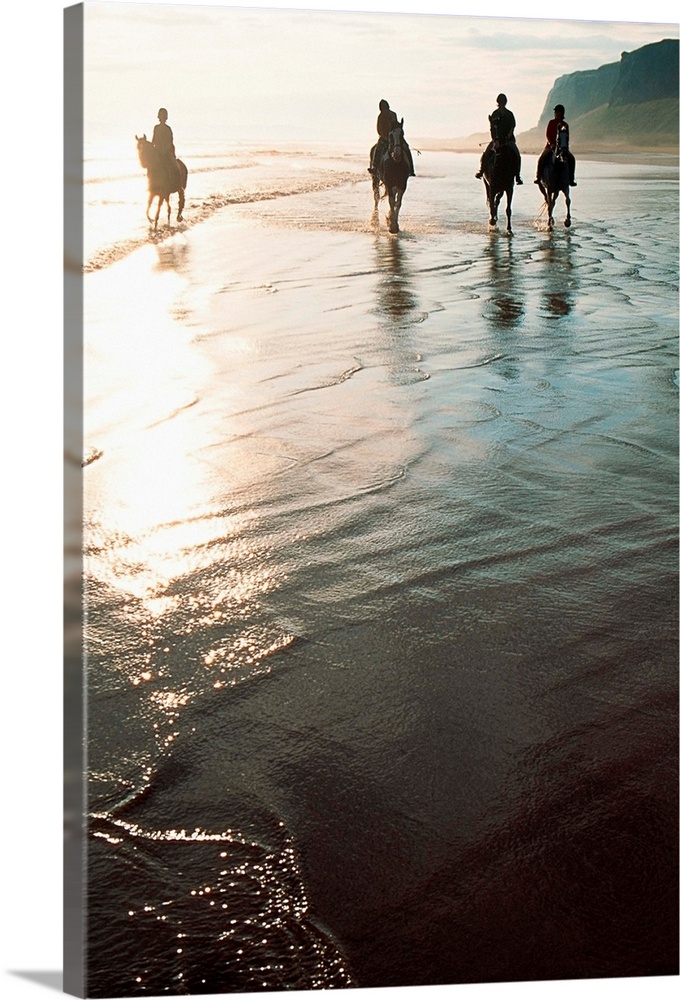 Four People Horseback Riding On A Coastal Beach, Ireland
