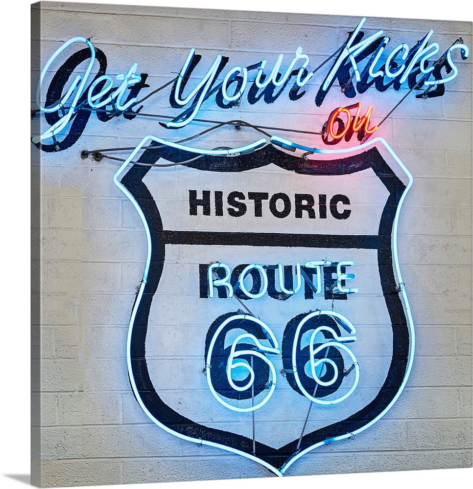 Square photograph of a neon Route 66 sign on a wall.
