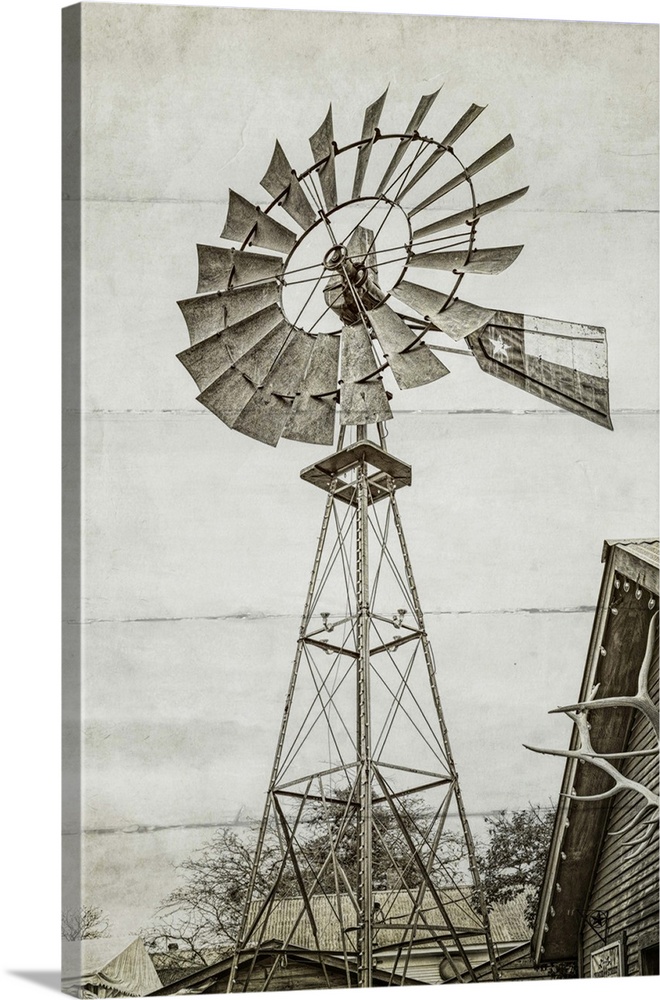 A black and white image of a windmill at a farm with a wood panel effect.