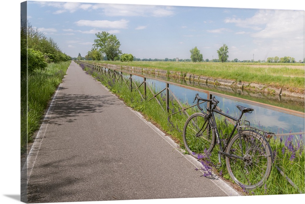 A bike on the rail of the Naviglio Pavense canal which links Milan to Pavia which has been transformed into a cycling path...