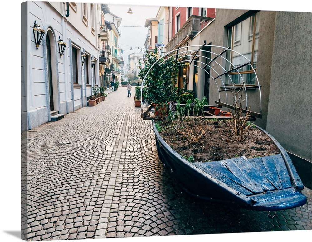 A boat filled with plants on a street in Stresa, Piedmont, Italy