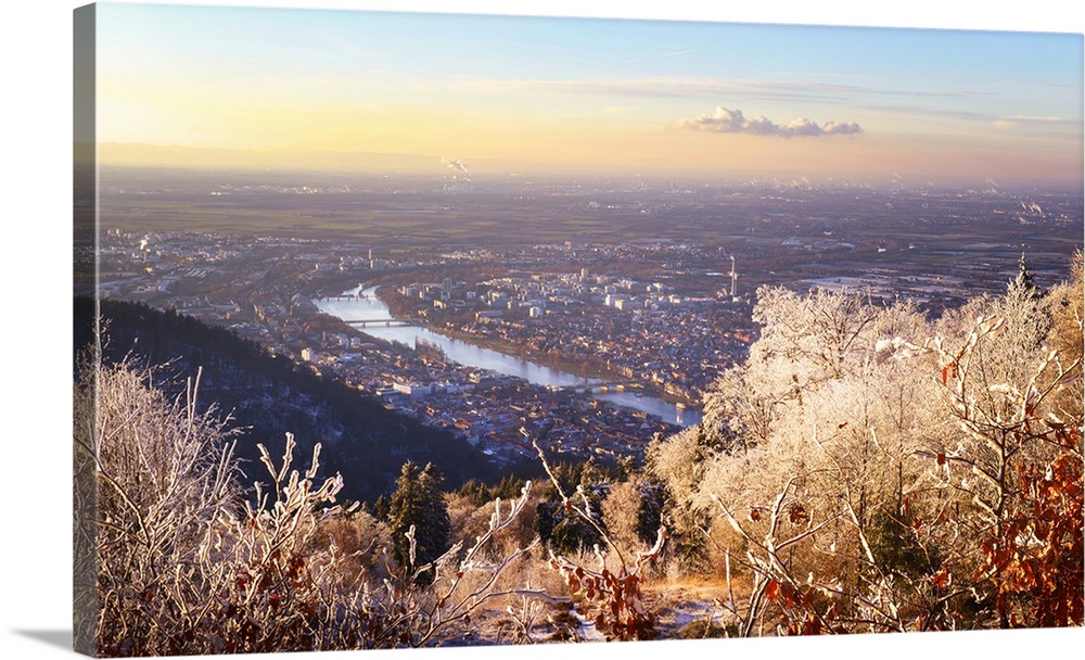 A dreamy view over Rhein Main Valley with Heidelberg City and Neckar River, framed by ice and rime covered trees, Baden-Wu...