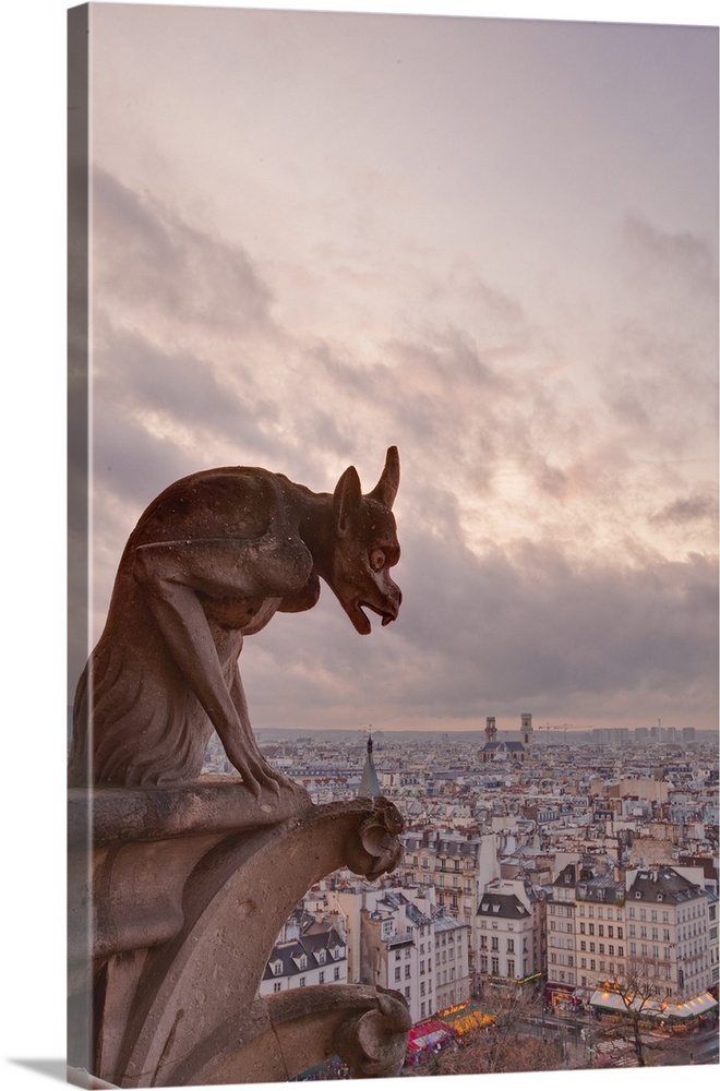 A gargoyle on Notre Dame de Paris cathedral looks over the city, Paris, France