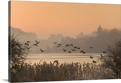 A misty sunrise over the Great Lake on the Castle Howard Estate, England