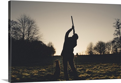 A Silhouette Of A Gun Shooting With A Gun Dog