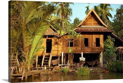 A traditional Thai house on stilts above the river in Bangkok, Thailand