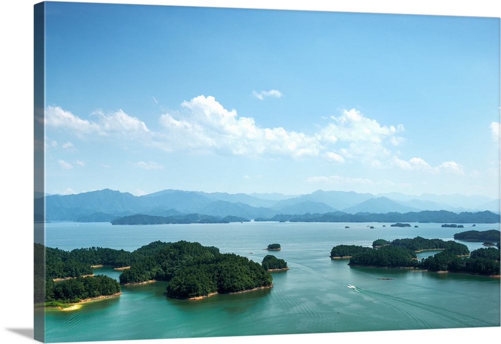 A white boat making its way across Qiandao (Thousand Islands) Lake, Chunan, Zhejiang, China, Asia