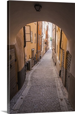 Arch and cobblestone alley in historic Gamla Stan, Stockholm, Sweden
