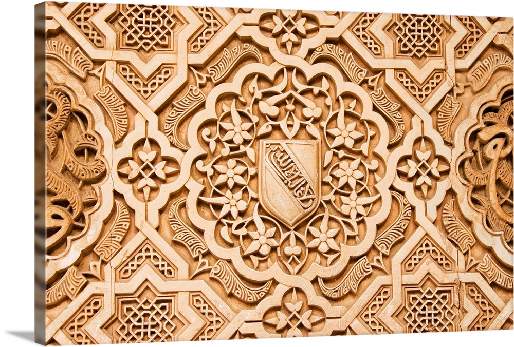 Atauriques (Moorish plaster work) in the Nasrid palace showing the shield of al Ahmur used as a decorative theme, Alhambra...
