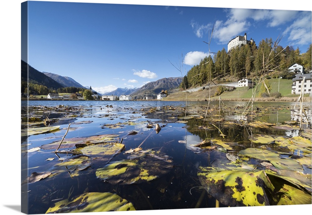 Autumn leaves in Lake Tarasp frame the old castle, Inn district, Canton of Graubunden, Engadine, Switzerland, Europe