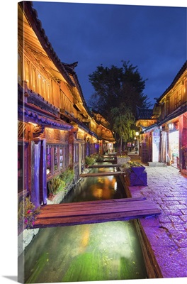 Bars and restaurants along canal at dusk, Lijiang, Yunnan, China