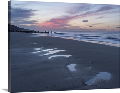 Beautiful sunset colours over the beach at low tide at Mundesley, Norfolk, England