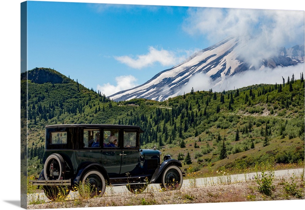 Beautifully restored Vintage American car passing Mount St. Helens, part of the Cascade Range Northwest region, Washington...
