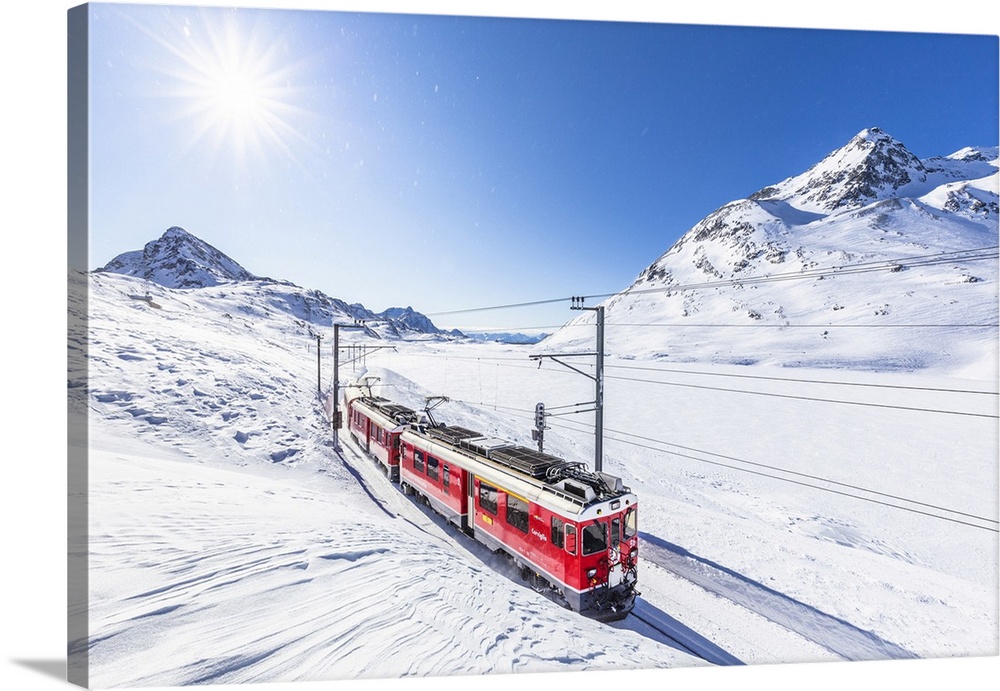 Bernina Express transit along Lago Bianco in winter, Bernina Pass, Engadine, Canton of Graubunden, Switzerland, Europe