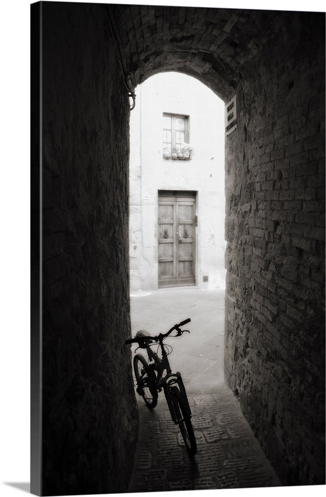 Bicycle in shady alleyway, San Quirico d'Orcia, Tuscany, Italy