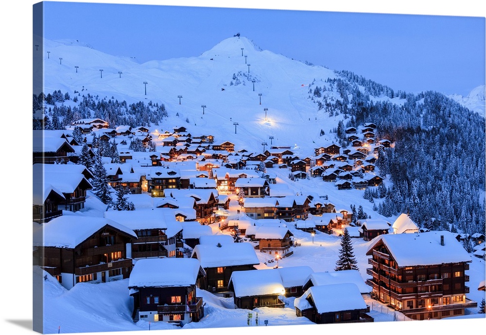Blue dusk on the snowy alpine village surrounded by ski lifts, Bettmeralp, district of Raron, canton of Valais, Switzerlan...