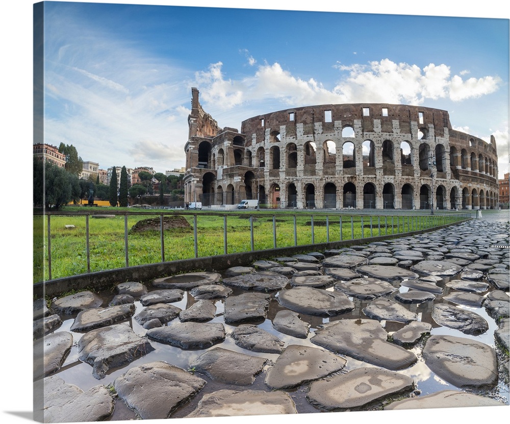 Blue sky at sunrise frames the ancient Colosseum, Rome, Lazio, Italy