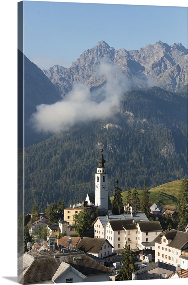 Blue sky on the alpine village of Ftan surrounded by rocky peaks, Inn district, Canton of Graubunden, Engadine, Switzerlan...