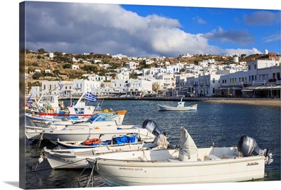 Boats in harbour, whitewashed town with windmills on hillside, Mykonos, Greece