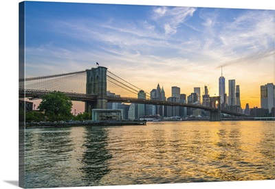 Brooklyn Bridge and Manhattan skyline at dusk, viewed from the East River, New York City