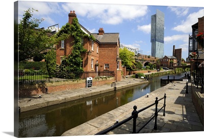 Canal and lock keepers cottage with the Beetham Tower, Manchester, England