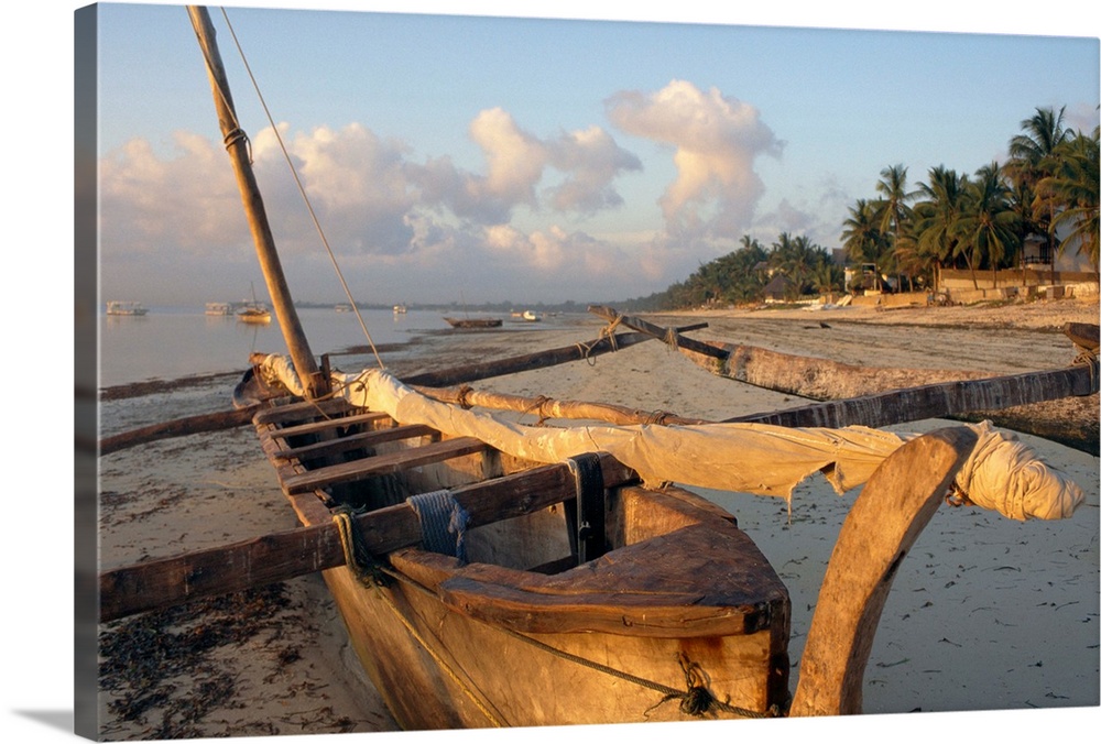 Canoe pulled up onto beach at dusk, Bamburi Beach, Kenya, Africa